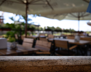 wooden table on blurred lightbulb cafe background