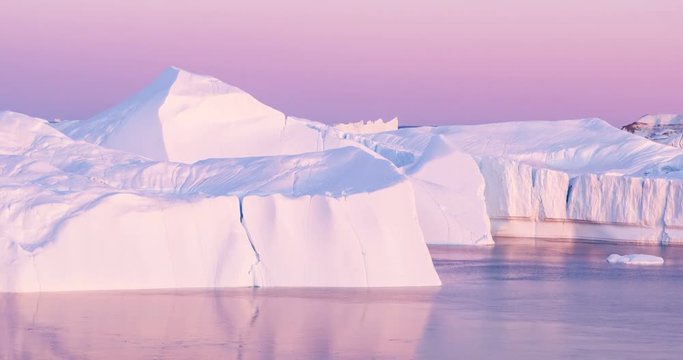 Climate Change. Iceberg and ice from glacier in arctic nature landscape on Greenland. Aerial video drone footage of icebergs in Ilulissat icefjord. famously affected by and global warming.