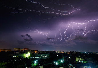 Bright night thunderstorm over the city