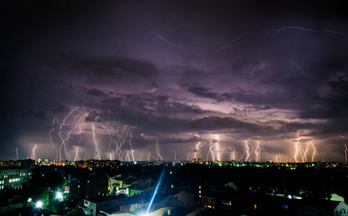 Bright night thunderstorm over the city