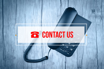 Hand Typing on keyboard with text CONTACT US