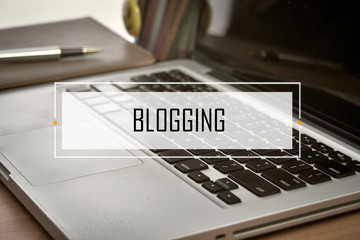 Notebook and Laptop with text BLOGGING