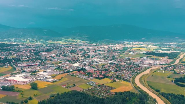 VILLACH, AUSTRIA - JUNE, 2019: Aerial drone view of Villach suburb with beautifil nature. Roads and railroads from above
