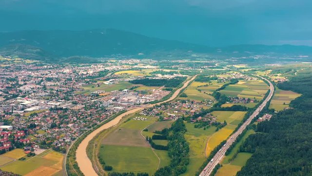 VILLACH, AUSTRIA - JUNE, 2019: Aerial drone view of Villach suburb with beautifil nature. Roads and railroads from above