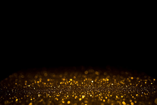 Fototapeta Golden abstract bokeh on black background. Holiday concept