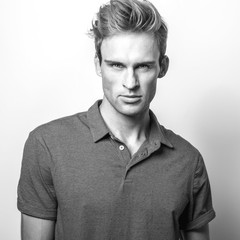 Elegant young handsome man in classic shirt. Black-white portrait.
