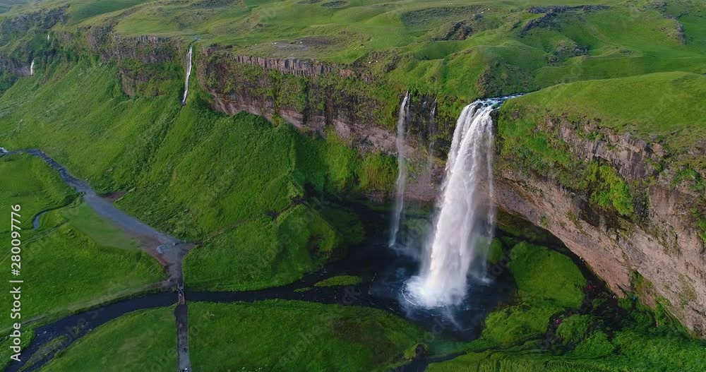 Wall mural Iceland Aerial drone 4K video of waterfall Seljalandsfoss in Icelandic nature. Famous tourist attractions and landmarks destinations in Icelandic nature landscape in South Iceland.