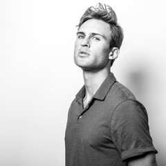 Fototapeta premium Elegant young handsome man in classic shirt. Black-white portrait.
