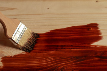 Brush dying wooden surface with mordant,closeup