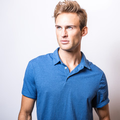 Elegant young handsome man in stylish blue shirt. 