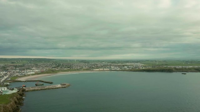  Aerial Flight over view of Ramore Head  area during sunset time, Portrush, Northern Ireland. Tourism Concept