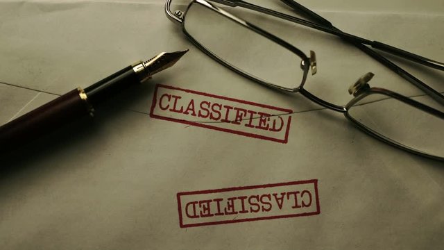 Close up of classified enveloop and glasses
