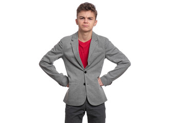 Angry handsome caucasian Teen Boy in gray suit isolated on white background. Upset Teenager looking at camera. Unhappy child - portrait.