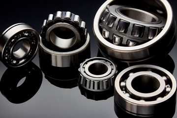 Close-up of a set of ball and roller bearings on a dark background