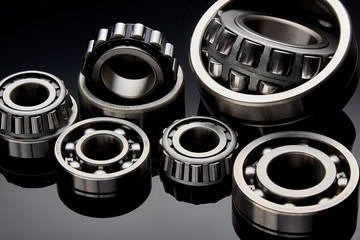 Close-up of a set of ball and roller bearings on a dark background