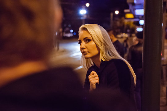 Young Woman Waiting For Uber Or Taxi In Evening