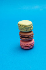 Colorful macaroons over a colored bakcground