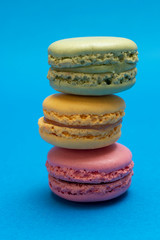 Colorful macaroons over a colored bakcground