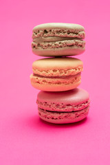 Colorful macaroons over a pink bakcground