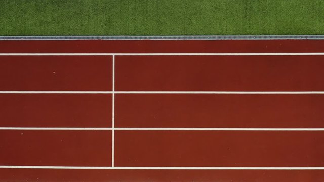 Athletic blonde woman running at open stadium