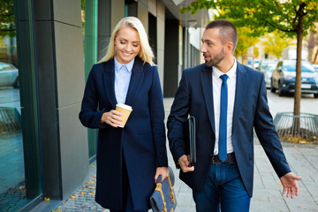 Businesswoman and businessman walking in the city