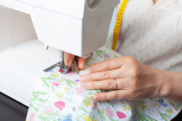 Dressmaker at work, building patterns, hands, modeling, measuring, sewing machine