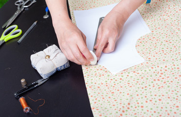 Dressmaker at work, building patterns, hands, modeling, measuring, sewing machine