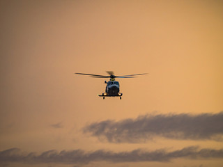 Fototapeta na wymiar Helicopter in the sunset over the Caribbean island of Curacao