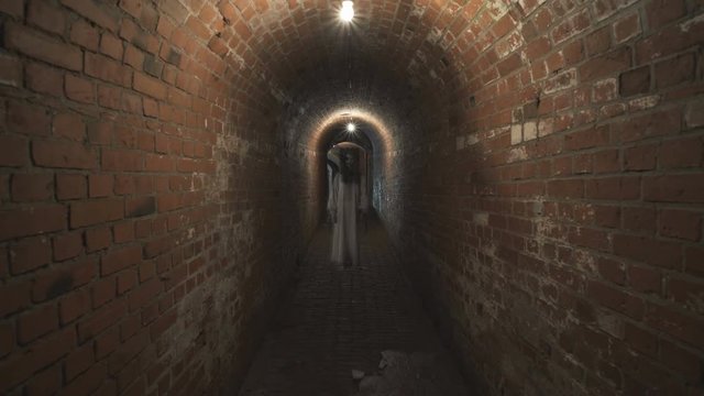 A ghost of a woman with a rusty cage on his head and with shackles on his hands wanders through the gloomy corridors of old dungeons.