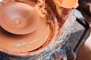 Simple pottery clay plate in a workshop background environment