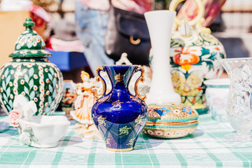 Old porcelain vases and other vintage objects at flea market, France