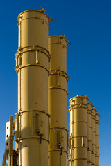 Antiaircraft missile launcher, military ballistic rockets ready to attack, blue sky on background, modern army industry 