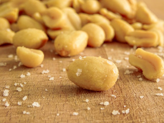 peanut on the wooden and blurry background salty close up