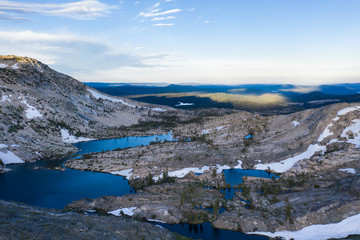 High granite mountains surround beautiful lakes in the Desolation Wilderness, California. This area is a popular backpacking destination and is full of granite rock formations and isolated lakes.