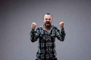 Angry man yelling and shaking his fists