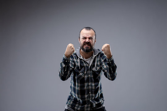 Man in a rage gnashing his teeth