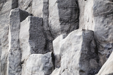 Natural stone texture. Basalt lava formations like columns. Icelandic typical natural background. Reynisfjara Beach Volcanic Basalt Coloumn Formations in Iceland.