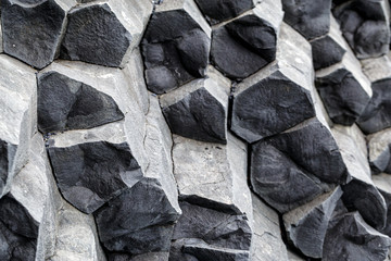Natural stone texture. Basalt lava formations like columns. Icelandic typical natural background. Reynisfjara Beach Volcanic Basalt Coloumn Formations in Iceland.
