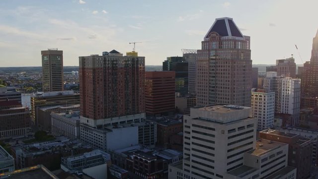 Baltimore Maryland Aerial v27 Flying toward inner harbor next to downtown high-rise cityscape with sun rays - October 2017
