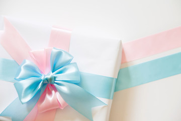 A gift for a boy and a girl at the same time. Surprise. Satin ribbon in blue and pink.