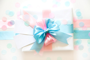 A gift for a boy and a girl at the same time. Satin ribbon blue and pink.