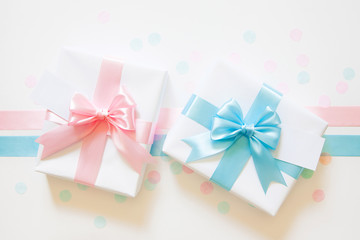 A gift for a boy and a girl at the same time. Surprise. Satin ribbon in blue and pink.