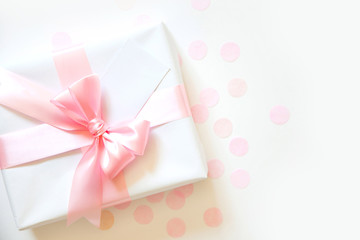 A gift for a girl. Surprise. Pink satin ribbon with bow.