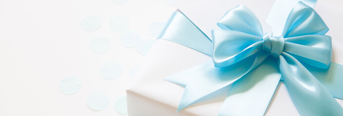 A gift for a boy. Surprise. Blue satin ribbon with bow.
