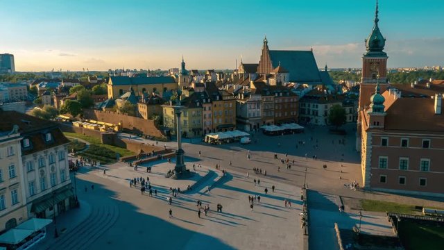 View on Old City Center Square with blue sky on background at Summer Evening Sunset From Above in Old Town in Warsaw, Poland. Time Lapse