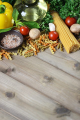Spaghetti ingredients on wooden, Italian food background.