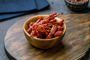 sun-dried tomatoes on wooden bowl