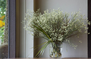 Dried flowers in pots with coffee shop background