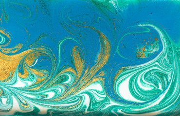 Fototapeta na wymiar Blue, green and gold marbling pattern. Golden powder marble liquid texture.