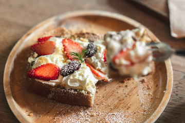 Fresh fruit toast  with soft white cheese in a wooden dish on table,  Bread for breakfast, Selective focus.